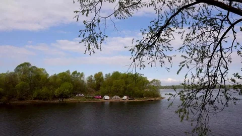 Beautiful view of the river through the trees, reflection of clouds on the water Stock Footage 109258844