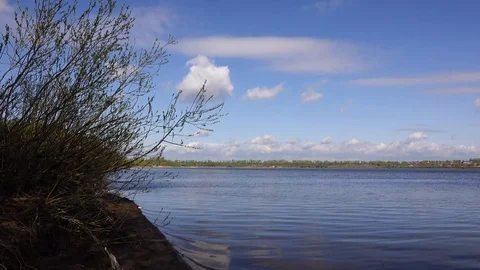 Beautiful view of the river through the trees, reflection of clouds on the water Stock Footage 109259419
