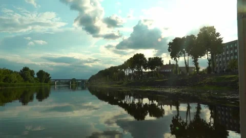 Beautiful view of river with trees and clouds in the evening near the city Vídeos de archivo 340447985