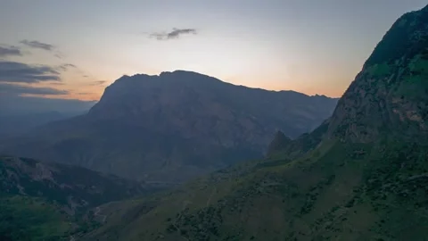 Beautiful view with rocks against the backdrop of mountains and the evening sky. Stock Footage 250679214