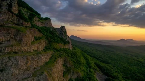 Beautiful view with rocks against the backdrop of mountains and the evening sky. Stock Footage 250767008