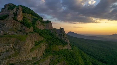 Beautiful view with rocks against the backdrop of mountains and the evening sky. Stock Footage 250771347