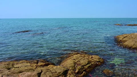 Beautiful view of rocks beach with blue ocean wave. Stock-Footage 154563979