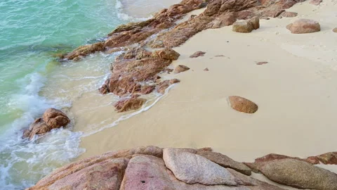 Beautiful view of rocks beach with blue ocean wave. Stock-Footage 156990355