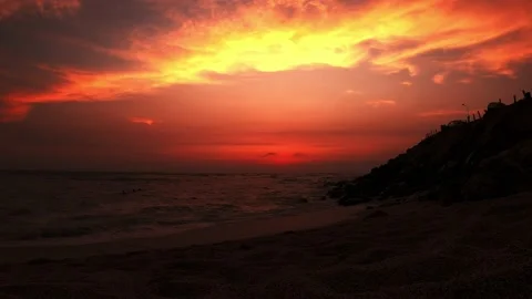 A beautiful view from the sand on the beach with the sunset on the beach and the Stock Footage 195131077
