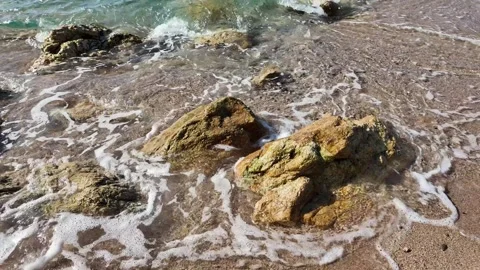 Beautiful view of the sea waves, foam, rocks on sandy beach, 4K background Stock Footage 277112151