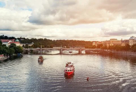Beautiful view of the ship floating on the river under the bridge in the summer Stock Photos