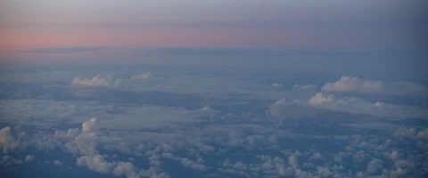 Beautiful view of skyline with clouds at sunset. View through an airplane window Stock Footage 127136387