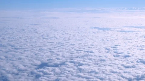 Beautiful view of the snow-white clouds from the airplane window in winter. Stock Footage 115938489