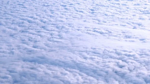Beautiful view of the snow-white clouds from the airplane window in winter. Stock Footage 115938533