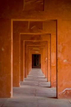 Beautiful view of a stoned path with columns in a row inside of a building at 스톡 사진