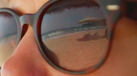 Beautiful view of summer beach reflecting in sunglasses wearing by woman Stock Footage 61650221