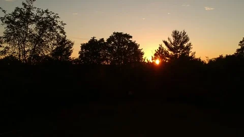 Beautiful view of a sunset against the silhouette of the trees and forest Stock Footage
