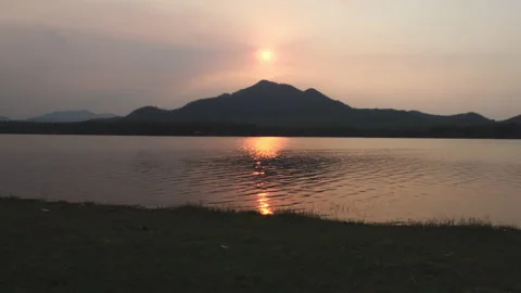 Beautiful view of the sunset over the calm waters of the lake. Stock Footage 172541385