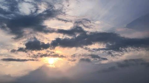 Beautiful view of sunset rays in the sky breaking through the clouds Stock Photos