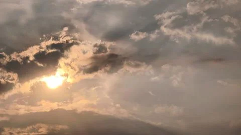 Beautiful view of sunset rays in the sky breaking through the clouds Stock Photos