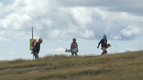 Beautiful view of three longboarders walking on Transalpina Stock Footage 57786259