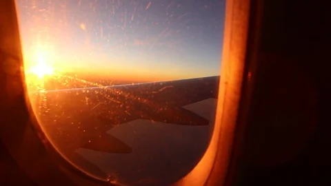 Beautiful View Through Airplane Illuminator to Sunset Stock Footage 82276405