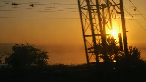 Beautiful view from the train on the surising orange sun, trees lines and Stock Footage 109012273