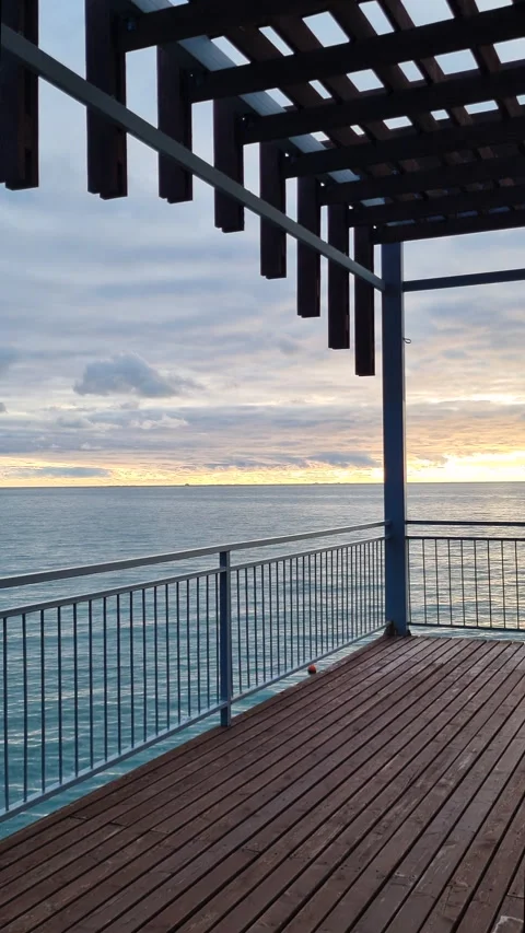 Beautiful view of a tranquil sea during a cloudy sunrise Stock Footage 327124331