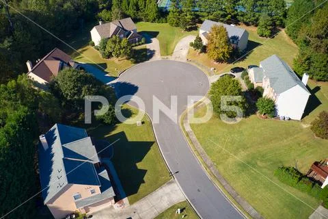 Beautiful view of an upscale sub division with golf course and a pond in suburbs
