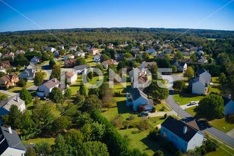 Beautiful view of an upscale sub division with golf course and a pond in suburbs