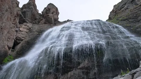 Beautiful view of a waterfall in a mountain gorge in the North Caucasus Stock Footage 284124332