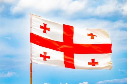 Beautiful view to waving flag of Georgia on the Georgian military road agains Stock Photos