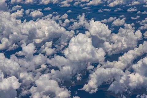 Beautiful view from the window of a plane flying over clouds. Stock Photos
