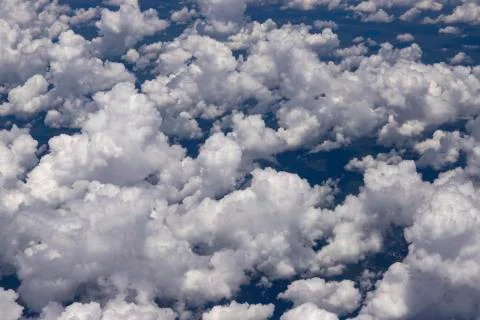 Beautiful view from the window of a plane flying over clouds. Stock Photos