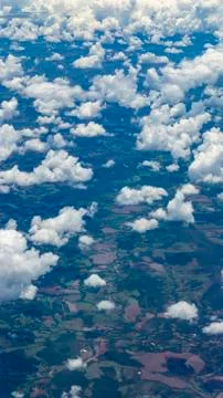 Beautiful view from the window of a plane flying over clouds. Stock Photos