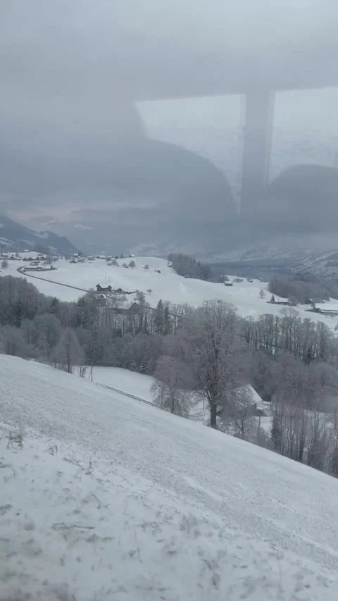 A beautiful view of winter mountains from a window of a train in Switzerland. Stock Footage 329887524