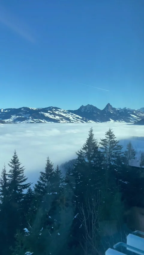 A beautiful view of winter mountains  from a window of a train in Switzerland Video stock 329888241