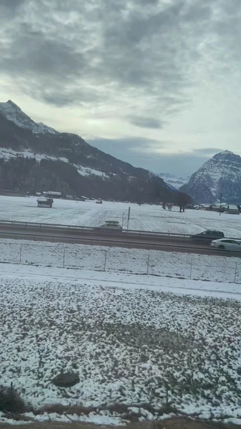 A beautiful view of winter mountains from a window of a train in Switzerland Video stock 329888483