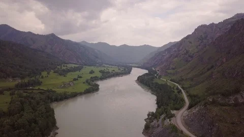 Beautiful views of the river from a bird's flight on a cloudy day. Cars passing Stock Footage 113686729