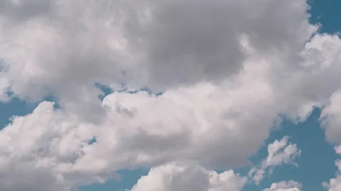 Beautiful volumetric clouds fly fast in the blue sky, background for the design Stock Footage 128958847
