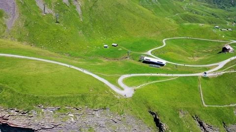 Beautiful Walking Path on top of a mountain with green meadows eiger trail Stock Footage 246983891
