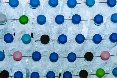 Beautiful wall made of multi colored recycled plastic bottles..Bottle recyc.. Stock Photos