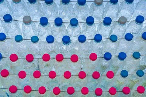 Beautiful wall made of multi colored recycled plastic bottles..Bottle recyc.. Stock Photos