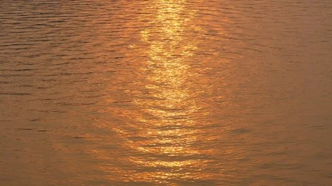 Beautiful warm sunset reflections on water surface Stock Footage 79435348