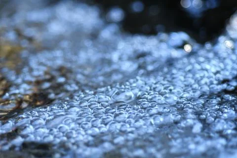 Beautiful water bubbles  in natural spring water with nice sparkling bokeh... Stock Photos