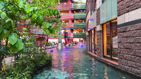 Beautiful water canal flows through the modern Canal City Hakata shopping mall. Stock Footage 334580156