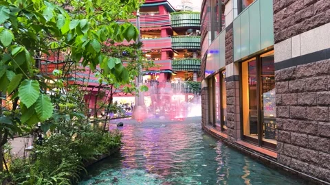 Beautiful water canal flows through the modern Canal City Hakata shopping mall. 库存影片 334580191