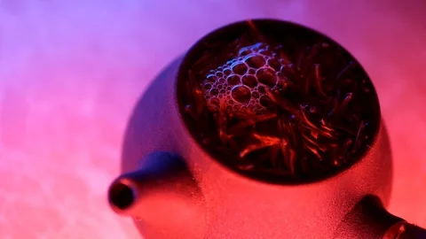 Beautiful water reflection of the neon light in the kettle of tea Stock Footage 115253636