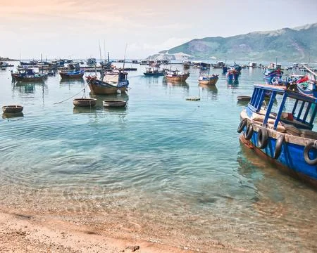 Beautiful water scenery with multiple rustic boats and round basket weave boa Stock Photos