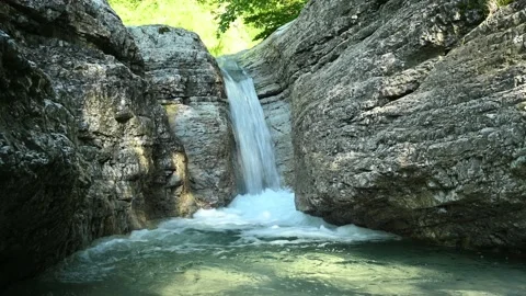 Beautiful waterfall in between rocks in the mountain. 動画素材 211496207