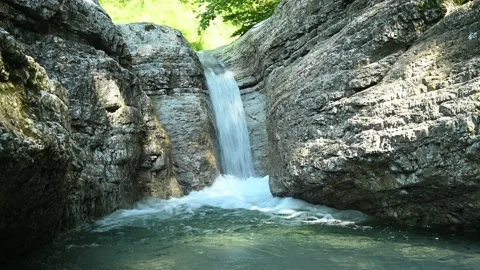 Beautiful waterfall in between rocks in the mountain. Stock Footage 211496717