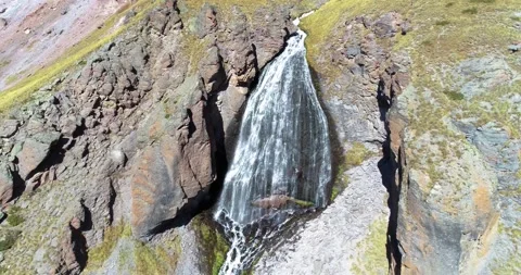 Beautiful waterfall between rocks on a mountainside Stock Footage 147101622
