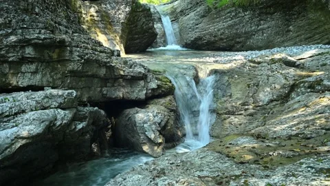 Beautiful waterfall between stones of a rivulet in the mountains Stock Footage 211491331