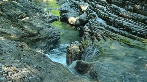 Beautiful waterfall between stones of a rivulet in the mountains Stock Footage 211491616